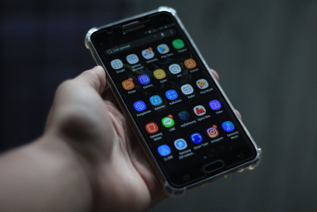Close-up of a smartphone showcasing various mobile applications on its display.